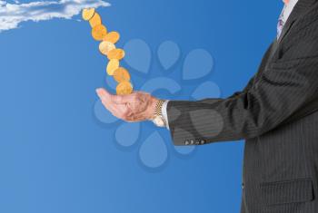 Senior caucasian businessman or executive isolated against white background. Subject is in profile and is collecting gold coins falling from blue sky