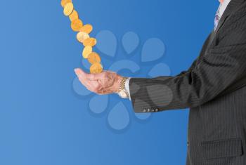 Senior caucasian businessman or executive isolated against white background. Subject is in profile and is collecting gold coins falling from blue sky