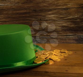 Treasure of pure gold coins inside a green velvet hat on wooden table to celebrate luck on St Patrick's Day of March 17th
