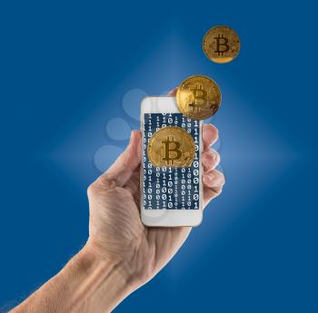 Gold bitcoins on blue background and emerging from app on smartphone to illustrate concept of blockchain for mobile money payments
