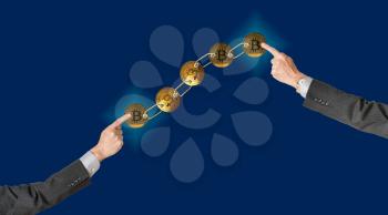 Set of gold bitcoins linked by chain on blue background with two arms pointing to ends to illustrate concept of blockchain for supply chain management
