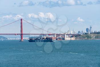 SAN FRANCISCO - APRIL 19: MOL container ship enters San Francisco Bay under Golden Gate Bridge on April 19, 2017. The MOL Magnificence is 289m long.
