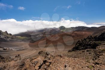 Different colors of rocks and lava in crater at top of Haleakala mountain on Hawaiian island of Maui