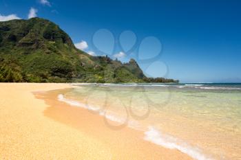 View down the sand at Tunnels Beach in summer on Hawaiian island of Kauai on North Shore