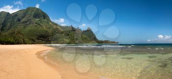 Panoramic view down the sand at Tunnels Beach in summer on Hawaiian island of Kauai on North Shore