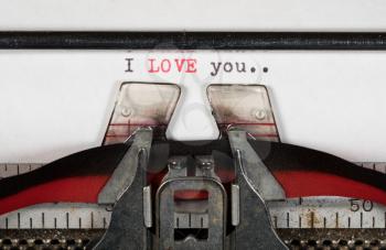 Macro detail of the ink ribbon and text of I Love You on electric typewriter for greeting card