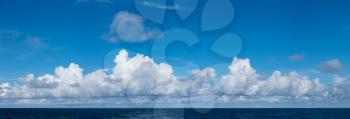 High resolution panoramic cloudscape of sunny clouds over the ocean
