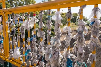 Tied cloths and plastic bags expressing love on bridge over Corinth Canal near Athens