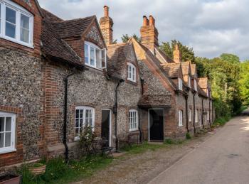 Street of brick homes and houses in the Chilterns village of Hambleden in Buckinghamshire