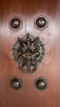 Solid wooden door with dragon head knocker
