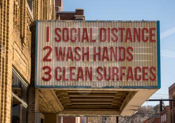 Movie cinema billboard with three basic rules to avoid the coronavirus or Covid-19 epidemic of wash hands, maintain social distance and clean surfaces