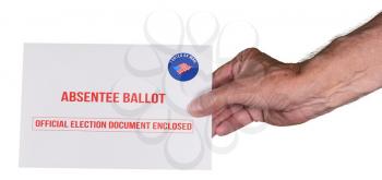 Absentee ballot voting by mail envelope being handed in by a senior man's hand as alternative to voting in person in Presidential election