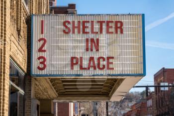 Movie cinema billboard with Shelter in Place message to avoid the coronavirus epidemic.