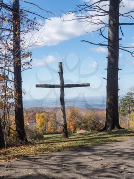 Simple wooden cross or crucifix overlooking the autumn landscape near Uniontown in Pennsylvania