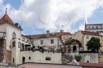 Restaurant with balcony below University of Coimbra on hilltop above the city from Santa Clara bridge