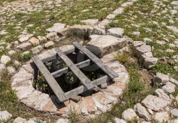 Stone well in the ruins of old Venetian fort above the coastal town of Novigrad in Croatia