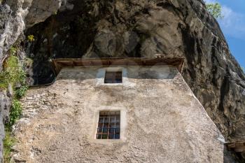 Famous castle of Predjama built into a cave in mountain in Slovenia