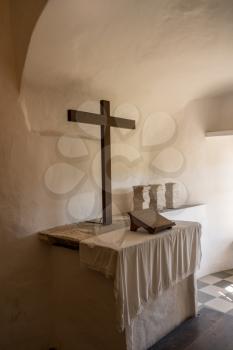 Simple and plain church altar in castle of Predjama built into a cave in Slovenia