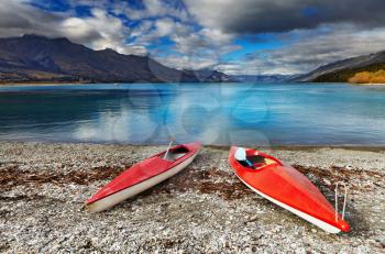 Red kayaks at the lakeside, Wakatipu Lake, New Zealand