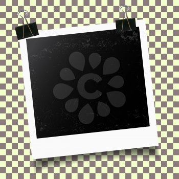 Retro photo frame with binder clip on checkered background. Vector illustration.