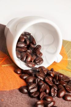 Background with coffee cup, autumn leaves and coffee beans 