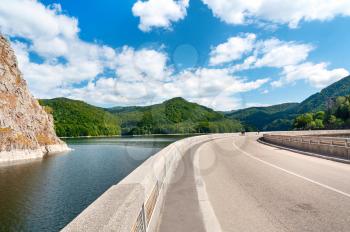 Vidraru artificial lake and dam on Arges river in Transylvania, Romania.  Highway in the Carpathian mountains, Fagaras ridge. Hydro electric power station