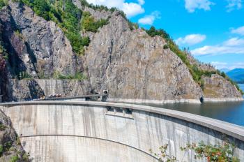 Vidraru dam on Arges river in Transylvania, Romania.  Hydro electric power station.  Fagaras ridge in the Carpathian mountains.