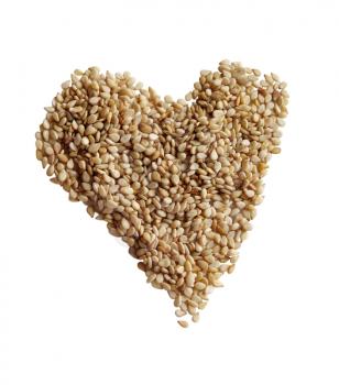 Sesame seeds in the form of heart on a white background