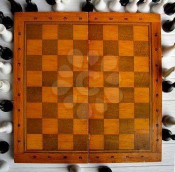 old chess around an empty chessboard classic wooden board