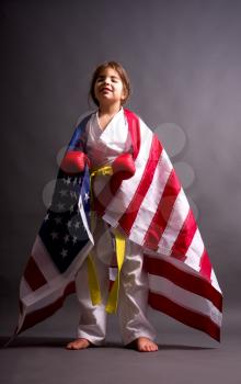Girl karate yellow belt with US flag winner of competition