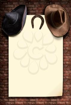two hats with a wide brim cowboy and Mexican hanging on a blank light background with a place for text on an old brick wall