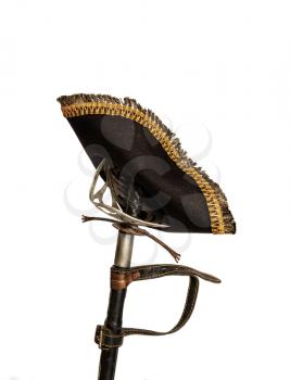 Classic pirate black felt captain's cocked hat hanging on an old scabbard in a scabbard isolated on a white background