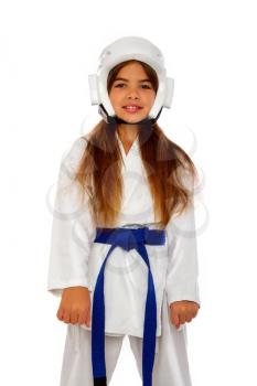 karate girl in a protective helmet with a blue belt and a white kimono smiling prepares for training