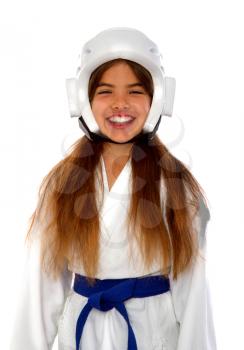 girl karateka in a protective helmet a blue belt and a white kimono with a mouth guard smiling prepares for training