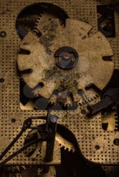 Close-up of an old dirty rusty brass clockwork with cuckoo clock gears