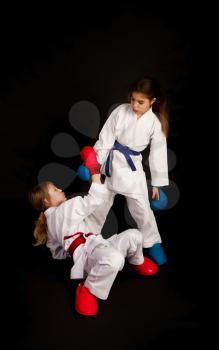 karate girl extends a helping hand to the second girl defeated after a successful attack in training
