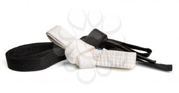 Black belt top skill and white entry level martial arts tied in a knot and isolated on white background