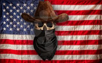 skull in cowboy hat and bandana against the background of the Stars and Stripes USA flag 