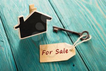 real estate sale concept - old key with tag