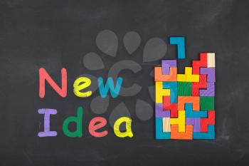 Business creative idea concept - inscription and jigsaw blocks on the blackboard