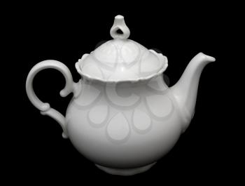 White porcelain teapot placed on the black background.