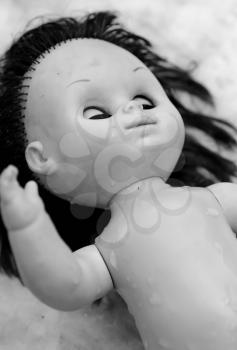 Black and white shot of scary plastic doll.