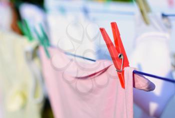 Closeup of the red peg with fresh laundry on the clothesline.