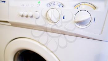 Closeup shot with control panel of washing machine.