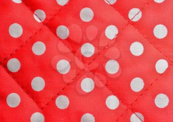Background shot of a red polka dot canvas with seams.