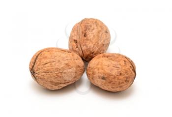 Group of three walnuts on white background.