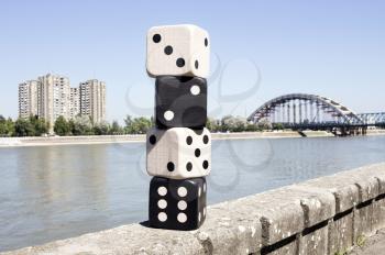 Dices Resting On The Wall With River And Cityscape in Background