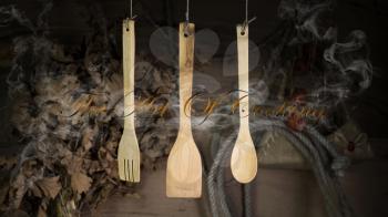 Kitchen Utensils Hanging On A Rope Against Rustic Wooden Background
