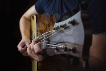 Acoustic Guitar Player Performing. Guitarist Playing In Music Studio