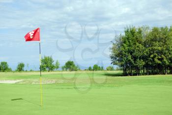 Golf course with red flag number three